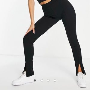 Rebellious Fashion slit front flared pants in black